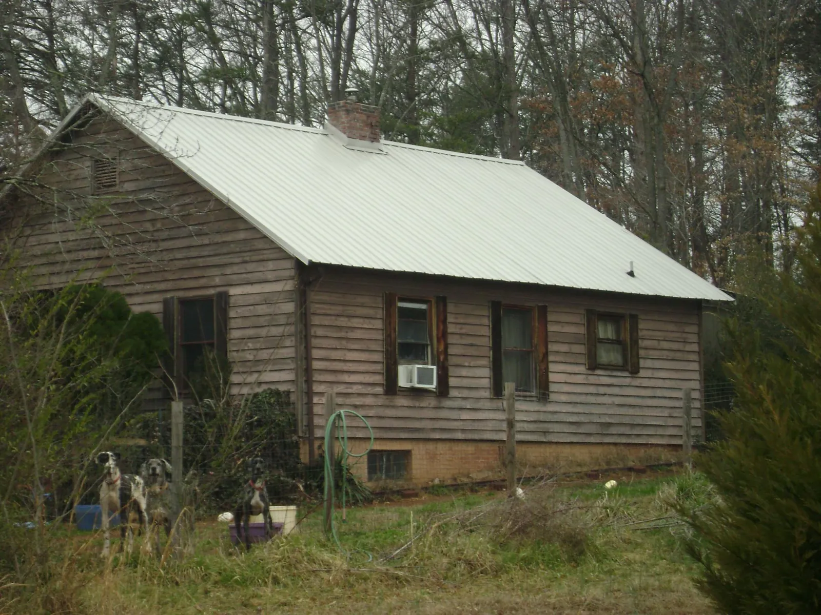 White metal roof on an old wood sided farmhouse, from a Metal Roof Installation job in Wilsons